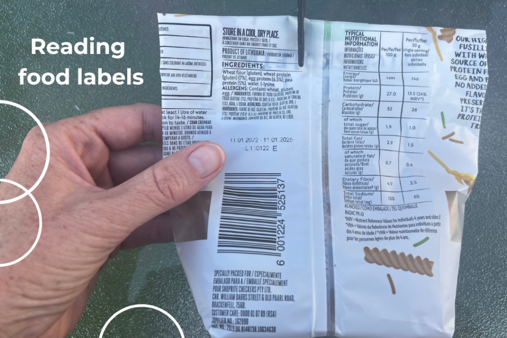 a hand holding food packaging with a food label