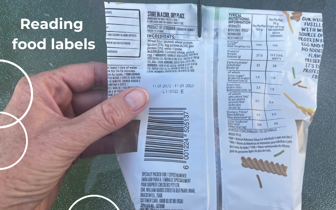 a hand holding food packaging with a food label